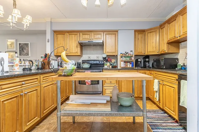 a kitchen with stainless steel appliances kitchen island granite countertop a sink and cabinets