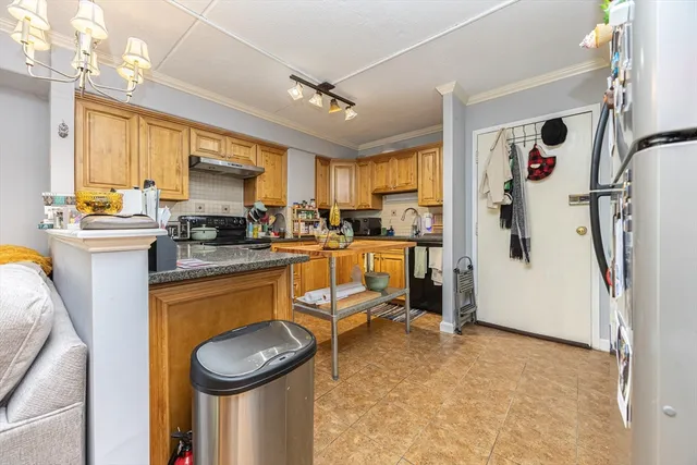 a kitchen with a sink appliances and cabinets