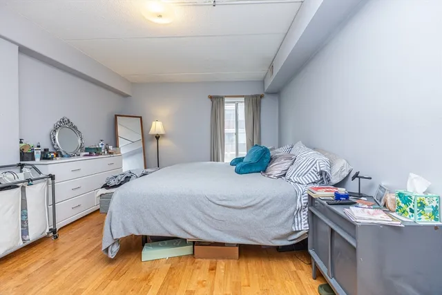 a bedroom with a bed and a dresser