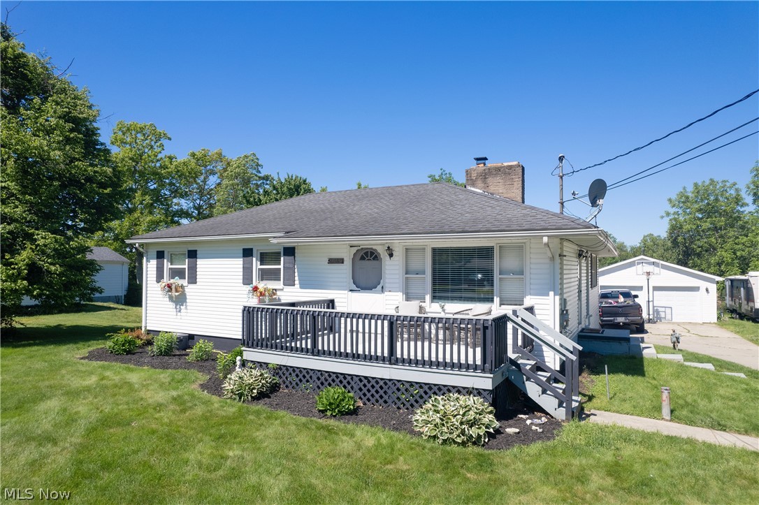 3659 Morrow Road Kent, OH 44240 - Photo 2 of 39 White siding exterior with a dark shingle roof and a front porch featuring dark railings