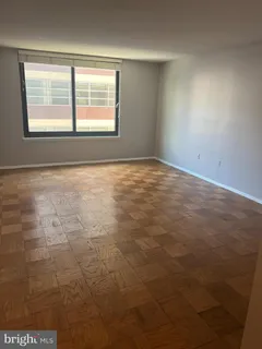 an empty room with a empty space and windows