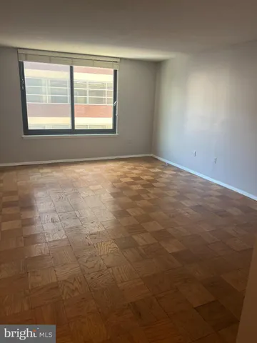 an empty room with a empty space and windows