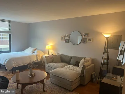 a living room with furniture and a mirror