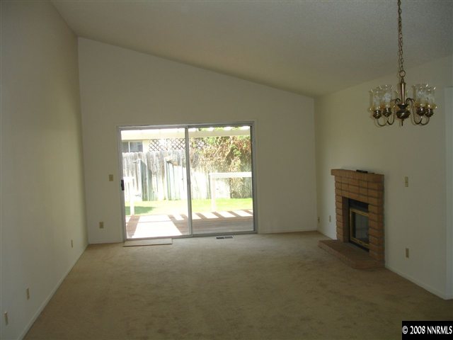4348 Pescado Way Reno, NV 89502 - Photo 2 of 9 a view of an empty room with a fireplace and a window