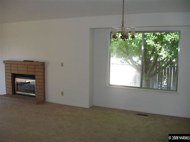 4348 Pescado Way Reno, NV 89502 - Photo 3 of 9 an empty room with windows and a fireplace