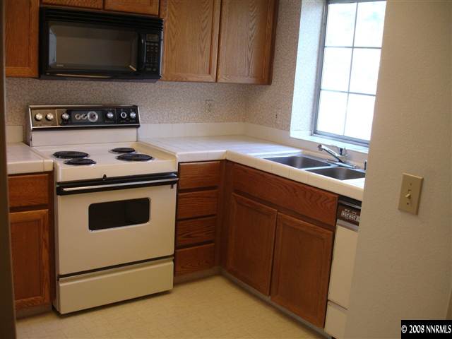 4348 Pescado Way Reno, NV 89502 - Photo 4 of 9 a kitchen with a stove microwave and sink