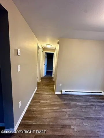 a view of a hallway with wooden floor