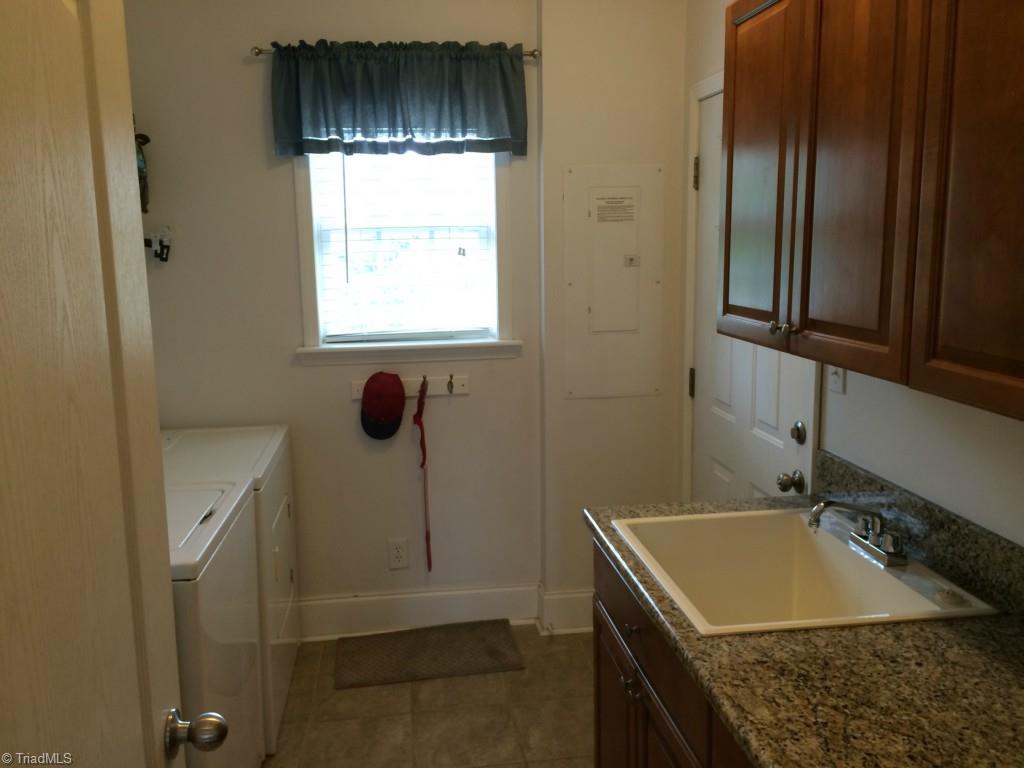 794 Sheep Farm Road Mount Airy, NC 27030 - Photo 25 of 30 Main level laundry sits between the 2 car garage and the kitchen.