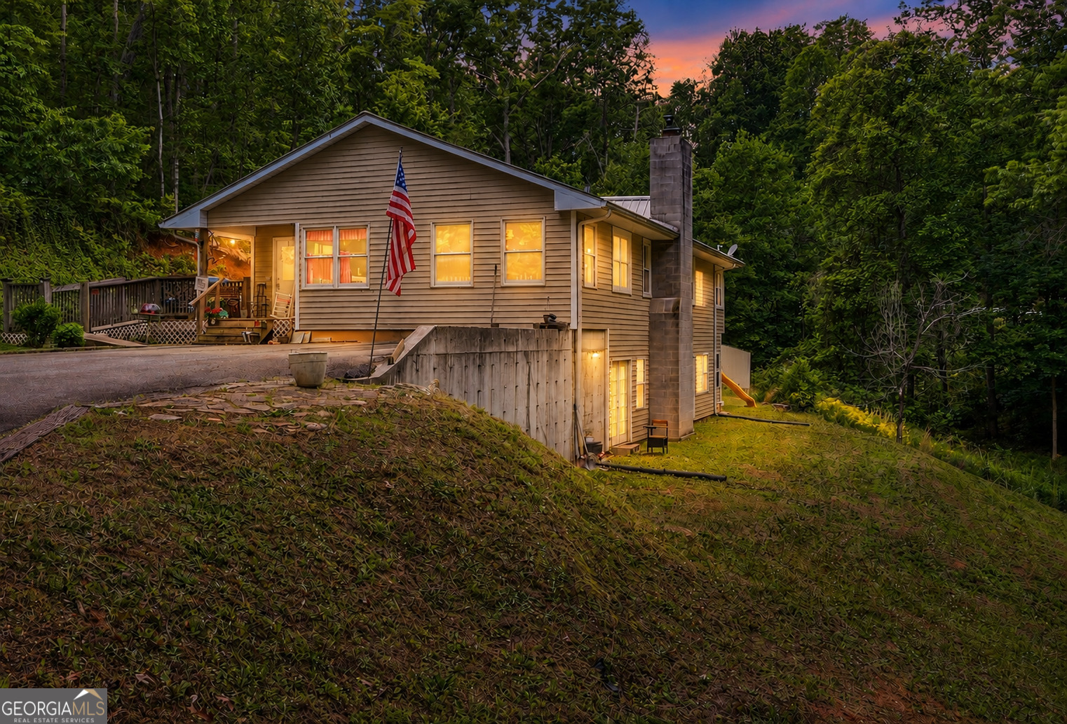 a front view of house with yard and green space