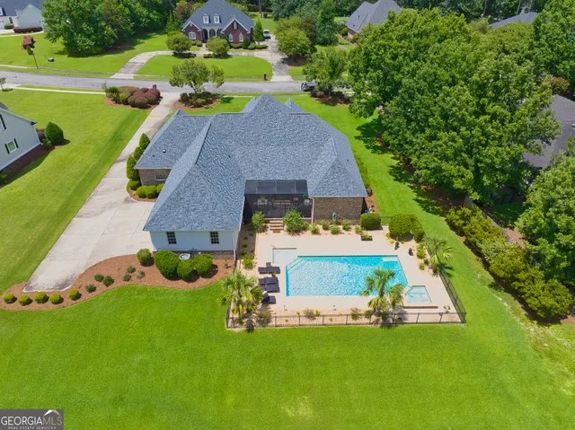 an aerial view of a house having swimming pool garden and patio