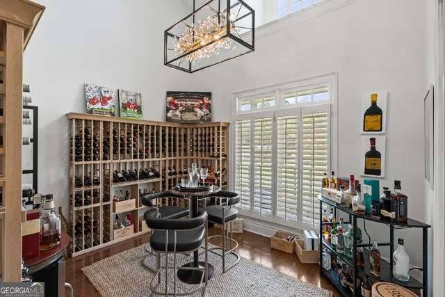 a bedroom with a bed and a lamp next to a large window