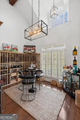 a bedroom with a bed a dresser and next to a window