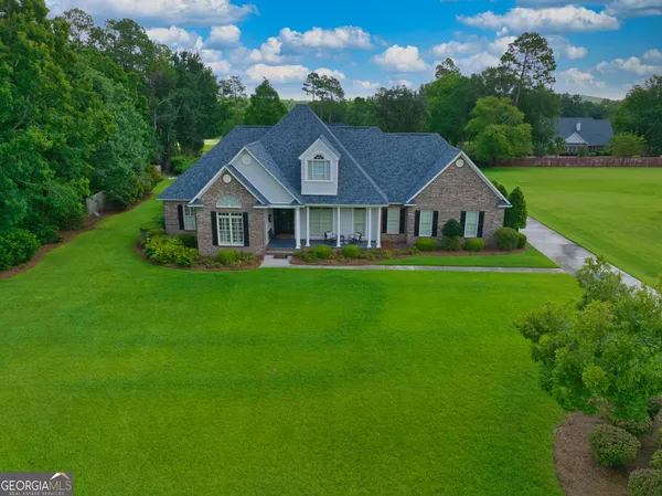 an aerial view of a house with a big yard