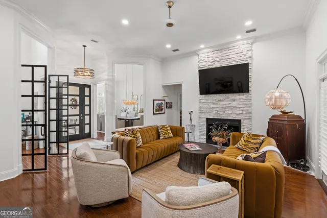 a living room with furniture a flat screen tv and a fireplace