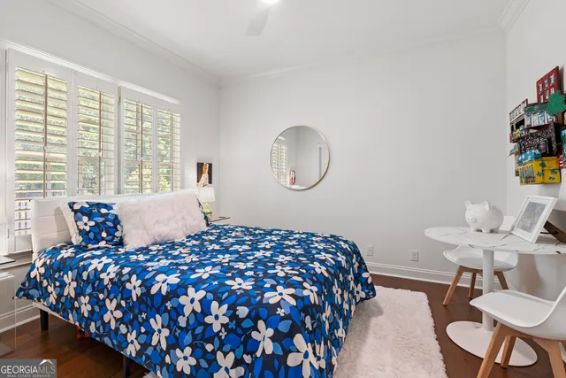a living room with furniture a mirror and white walls