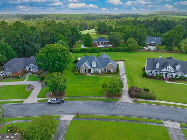 an aerial view of a golf course with chairs and garden