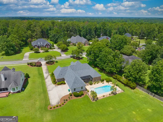 a view of a house with a backyard and a garden