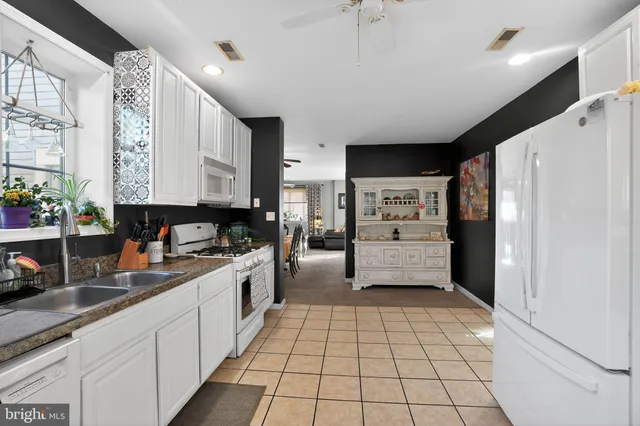 a kitchen with stainless steel appliances a refrigerator sink and cabinets