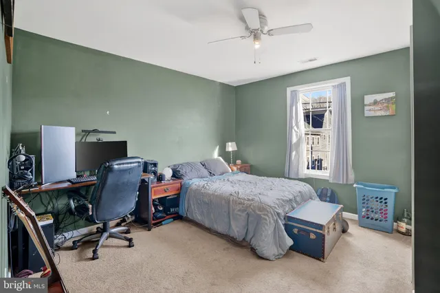 a bedroom with a bed chair and a window