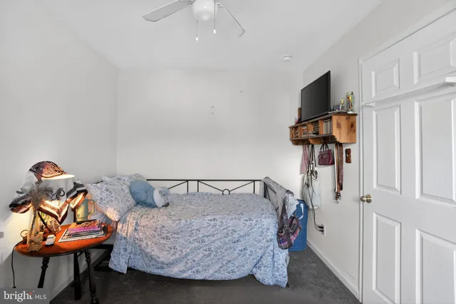 a bedroom with furniture and a flat screen tv