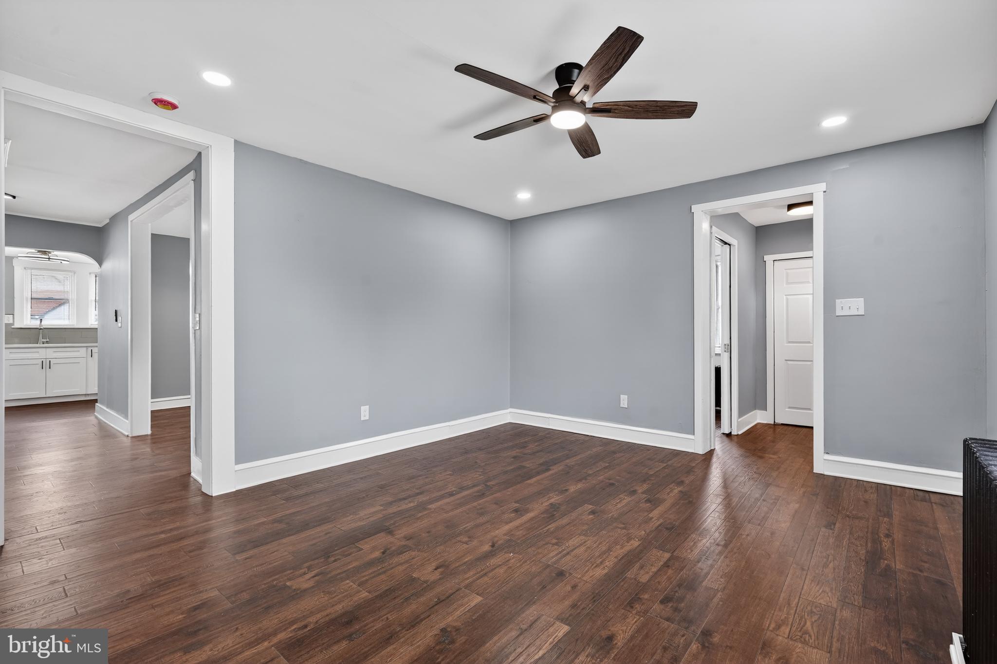 223 Noreg Place Brooklawn, NJ 08030 - Photo 8 of 36 an empty room with wooden floor and a ceiling fan
