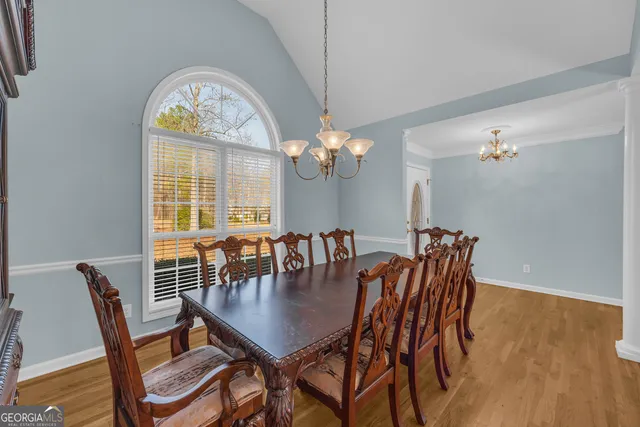 a view of workspace room with wooden floor and fan