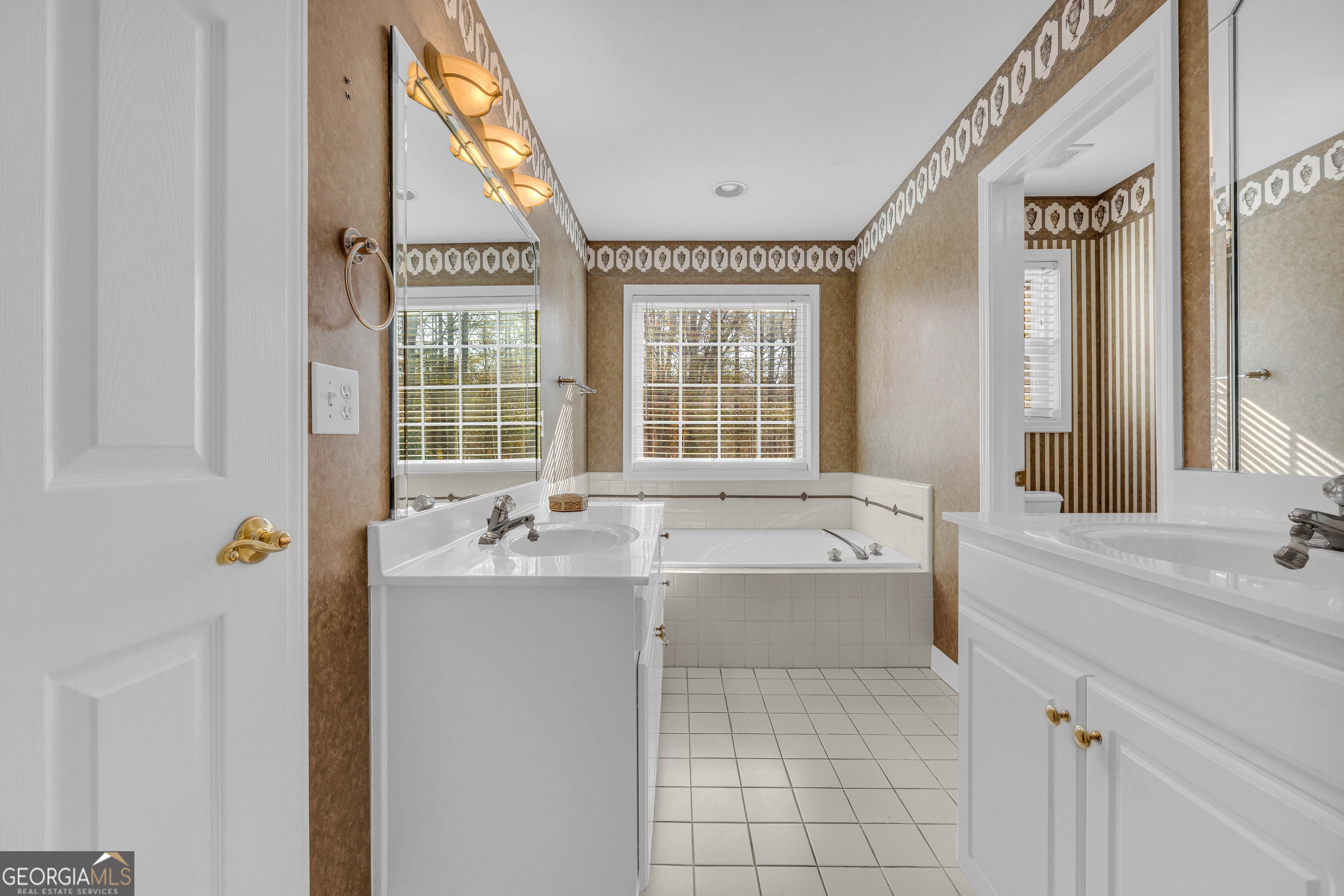 114 River Bluff Hoschton, GA 30548 - Photo 28 of 72 a bathroom with a tub sink and mirror