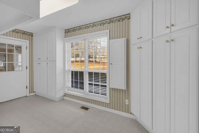 a view of an empty room with wooden floor