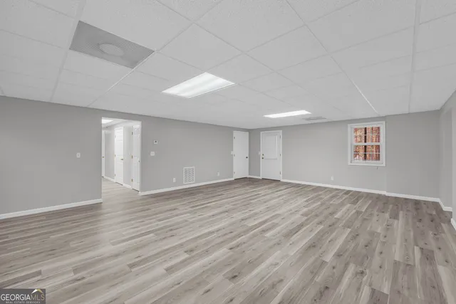 a large kitchen with granite countertop a white stove top oven and white cabinets