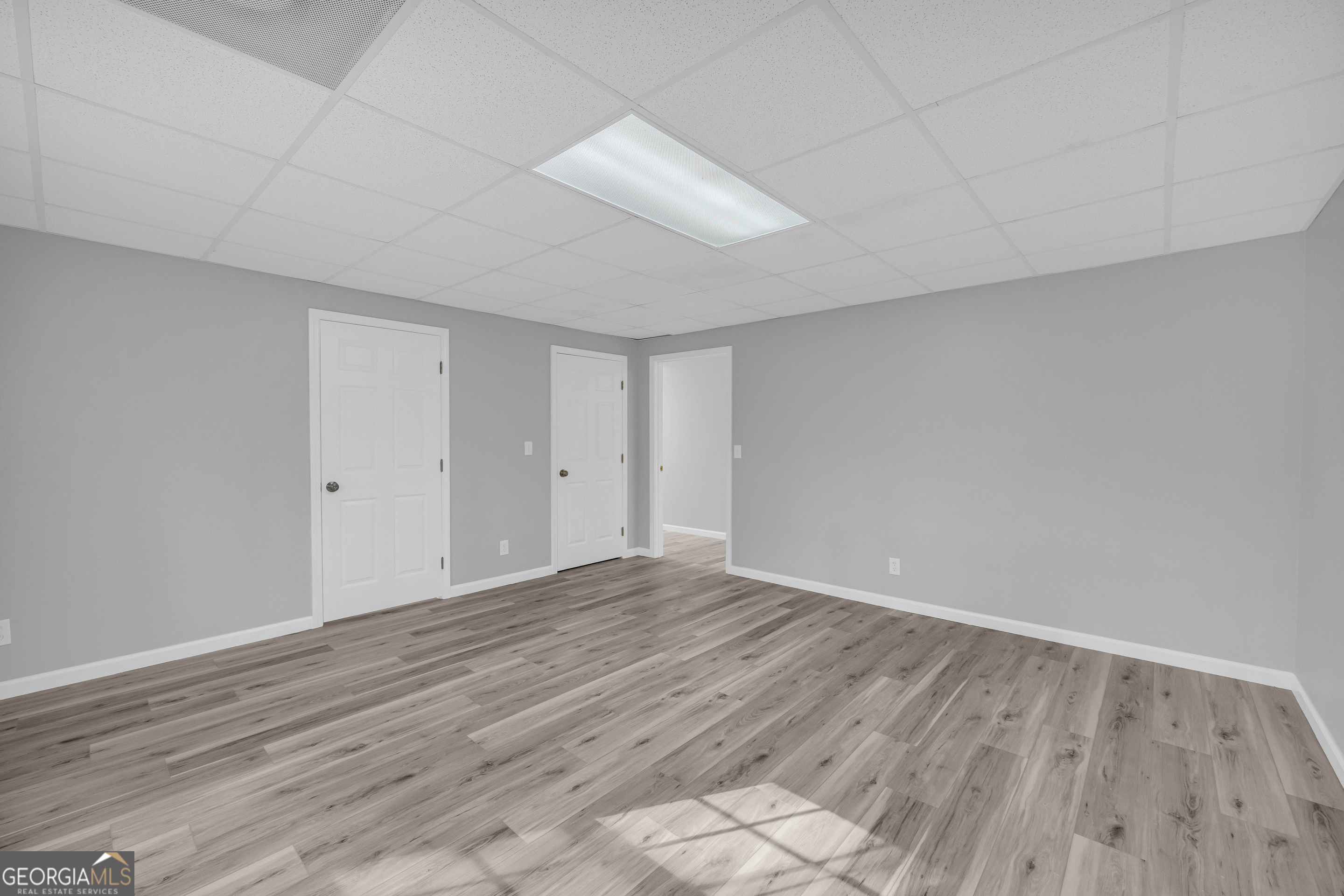 114 River Bluff Hoschton, GA 30548 - Photo 45 of 72 a view of an empty room with wooden floor