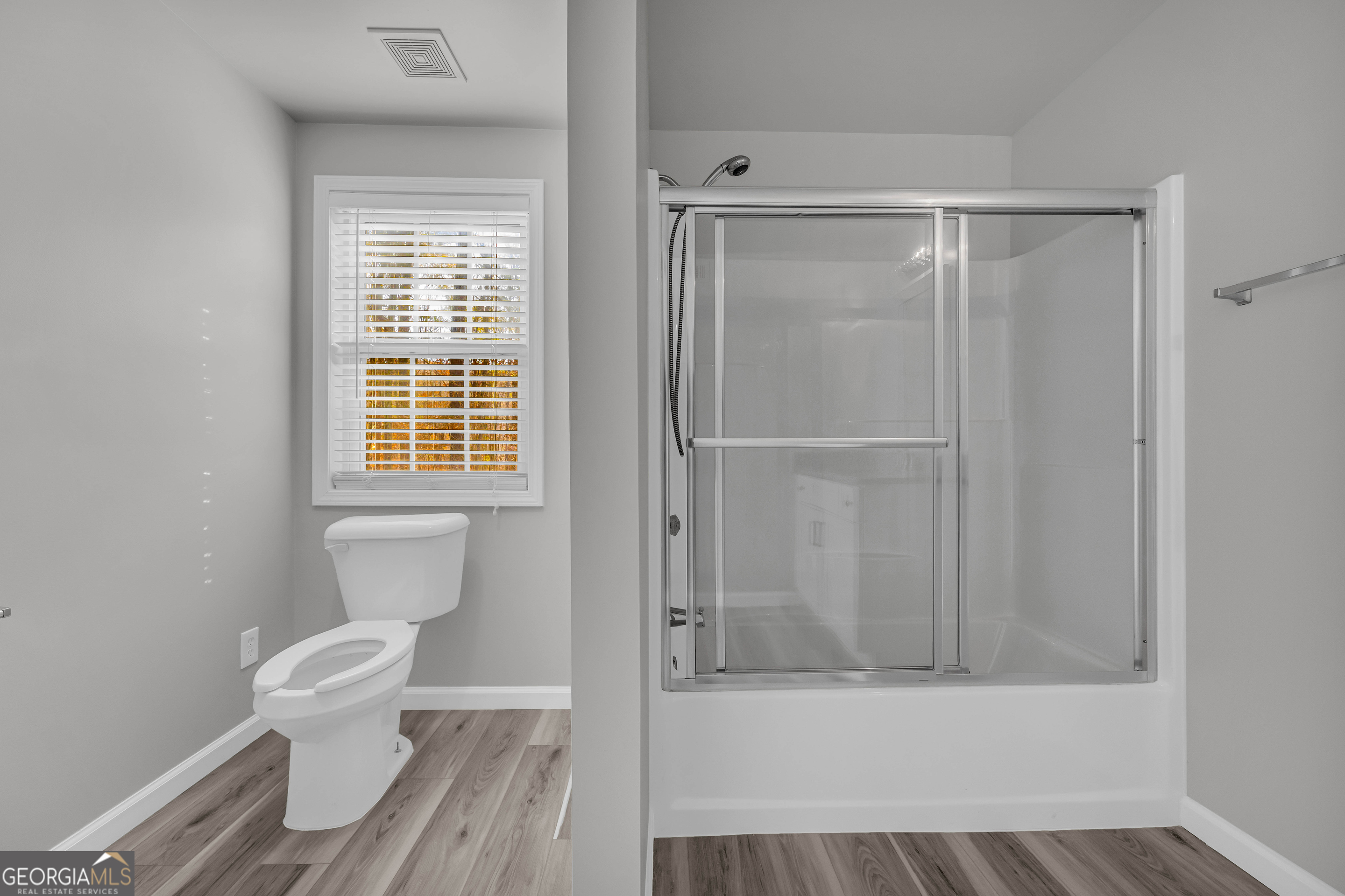 114 River Bluff Hoschton, GA 30548 - Photo 47 of 72 a bathroom with a toilet and a shower