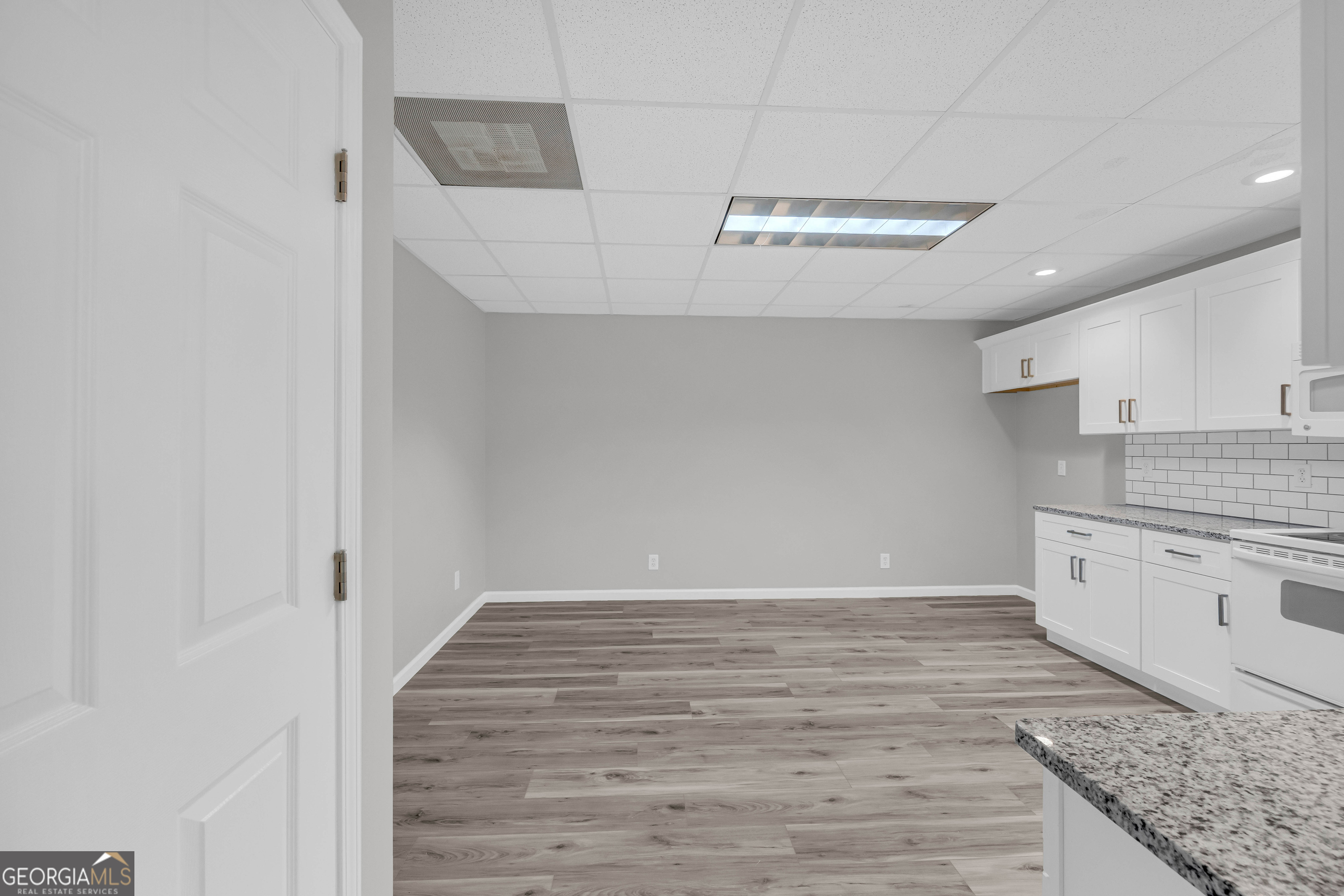 114 River Bluff Hoschton, GA 30548 - Photo 48 of 72 a view of a kitchen with granite countertop cabinets and wooden floor