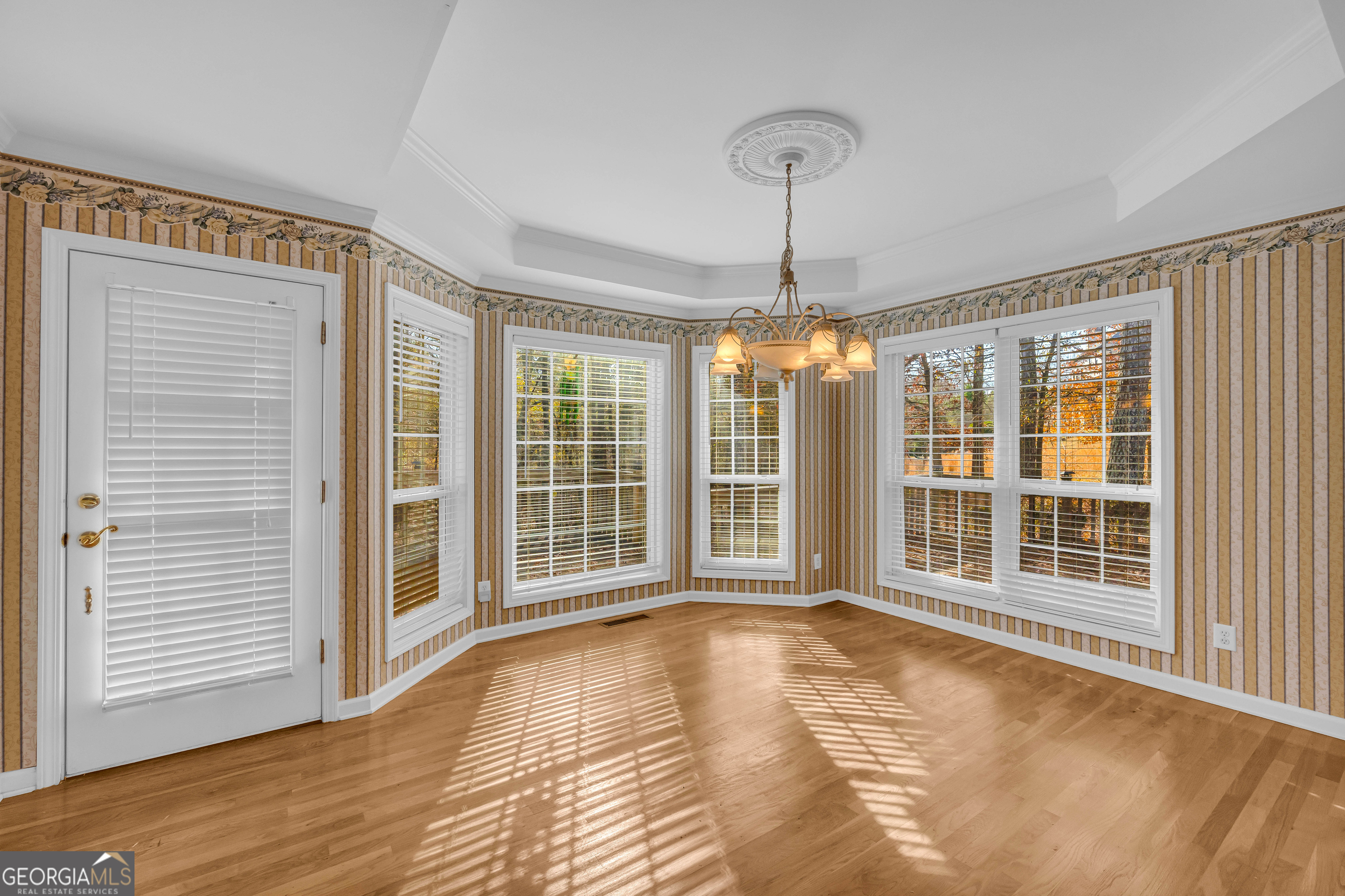 114 River Bluff Hoschton, GA 30548 - Photo 9 of 72 a view of an empty room with wooden floor and windows