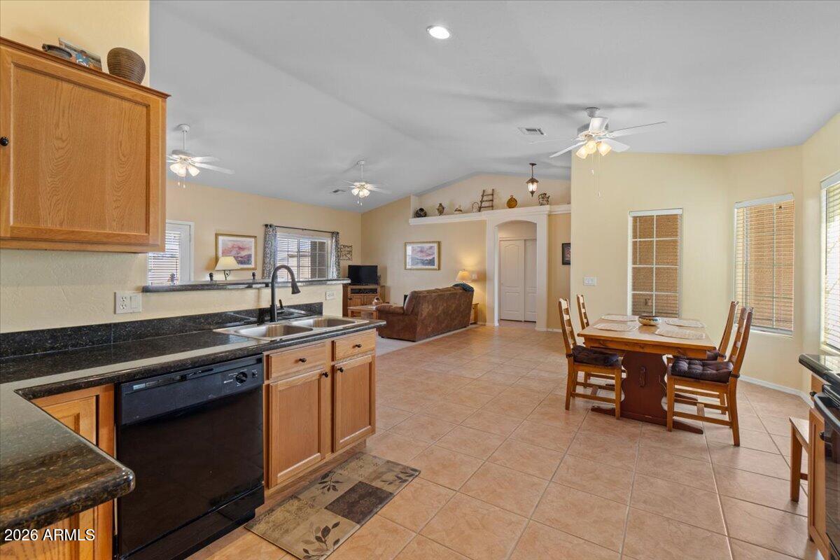 14234 South Capistrano Road Arizona City, AZ 85123 - Photo 10 of 42 a kitchen with stainless steel appliances granite countertop a sink and cabinets