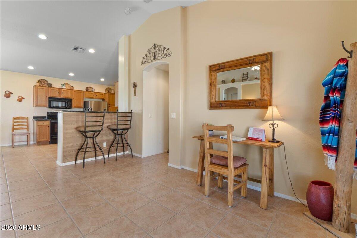 14234 South Capistrano Road Arizona City, AZ 85123 - Photo 16 of 42 a dining room with furniture and a kitchen view