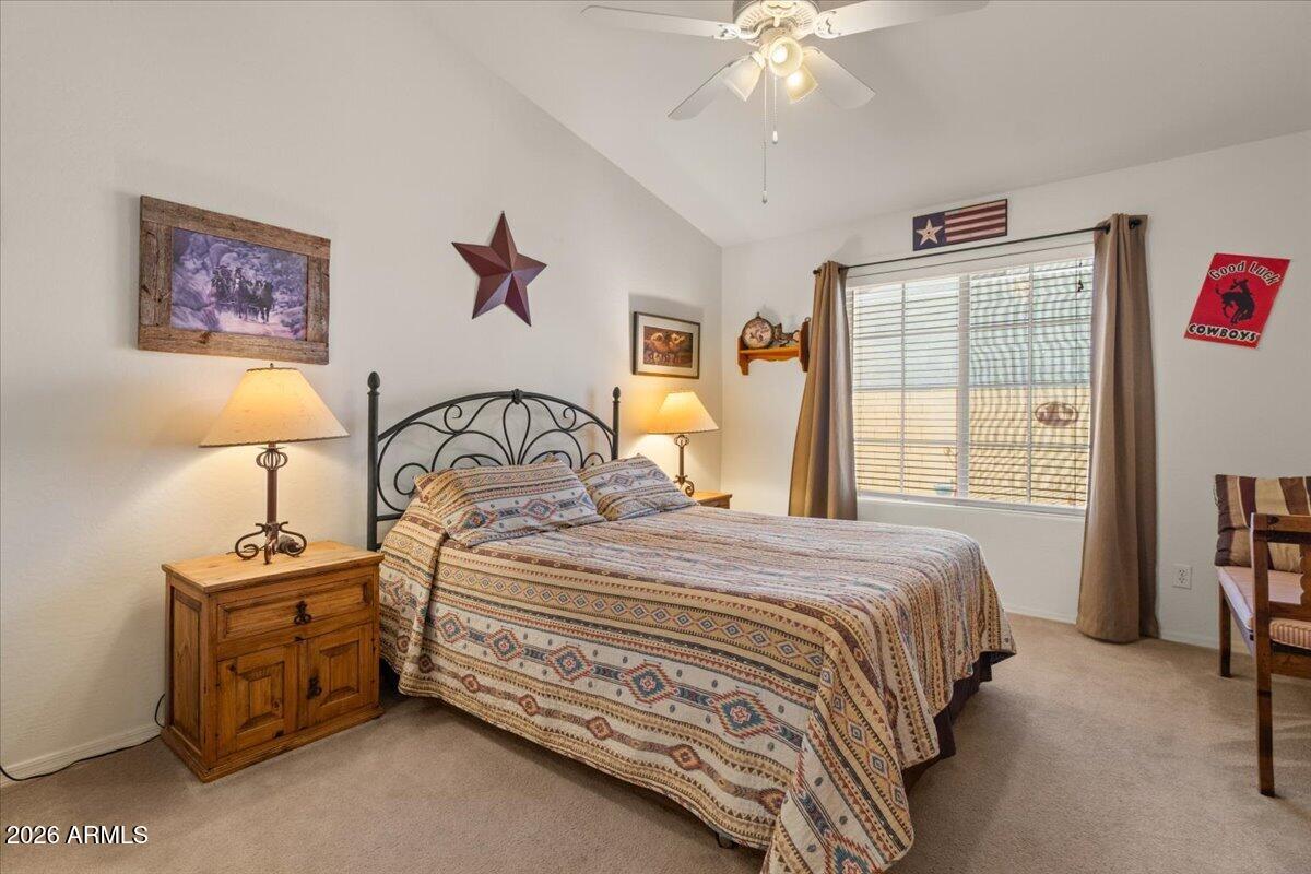 14234 South Capistrano Road Arizona City, AZ 85123 - Photo 18 of 42 a bedroom with a bed next to a window and a lamp on dresser