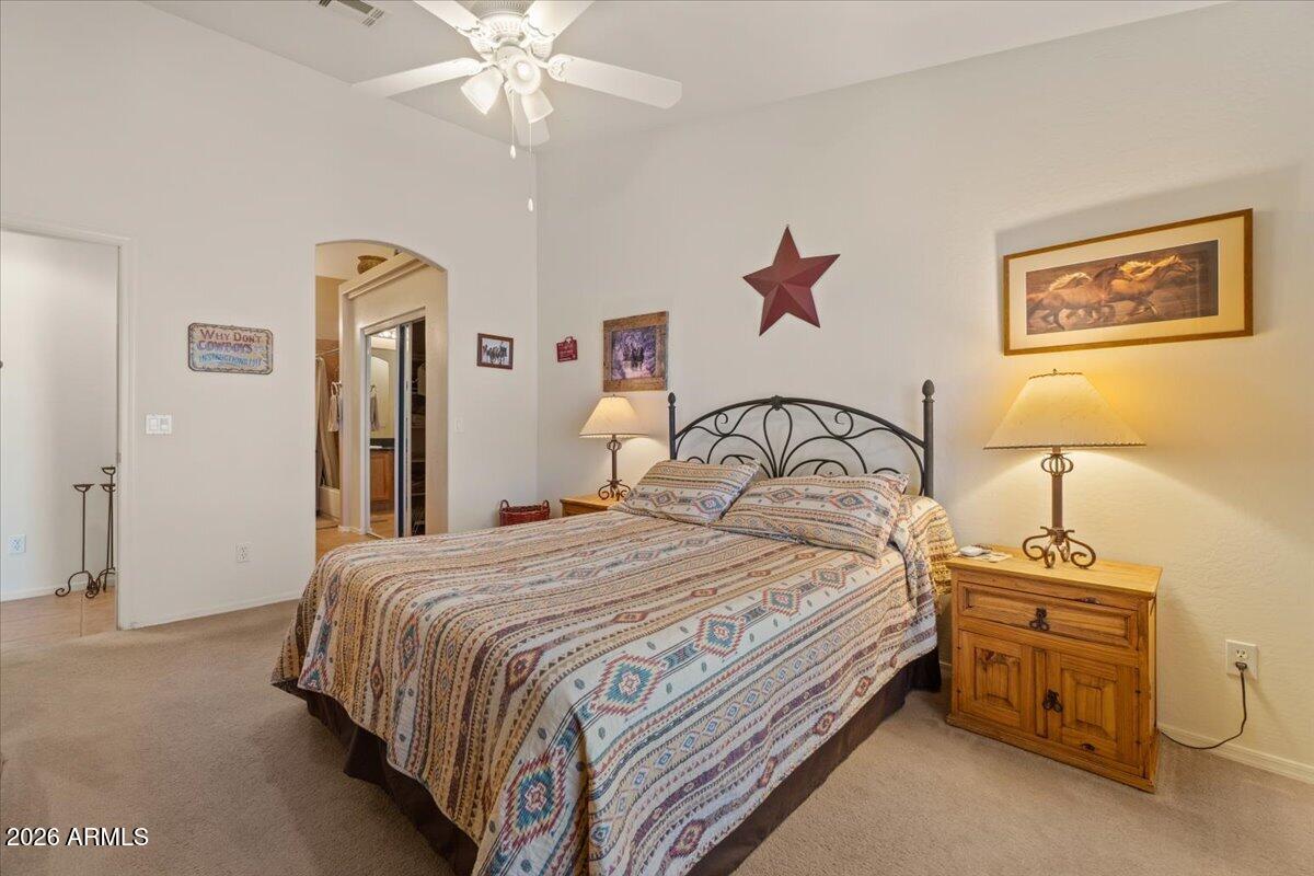 14234 South Capistrano Road Arizona City, AZ 85123 - Photo 19 of 42 a bedroom with a bed and a chandelier