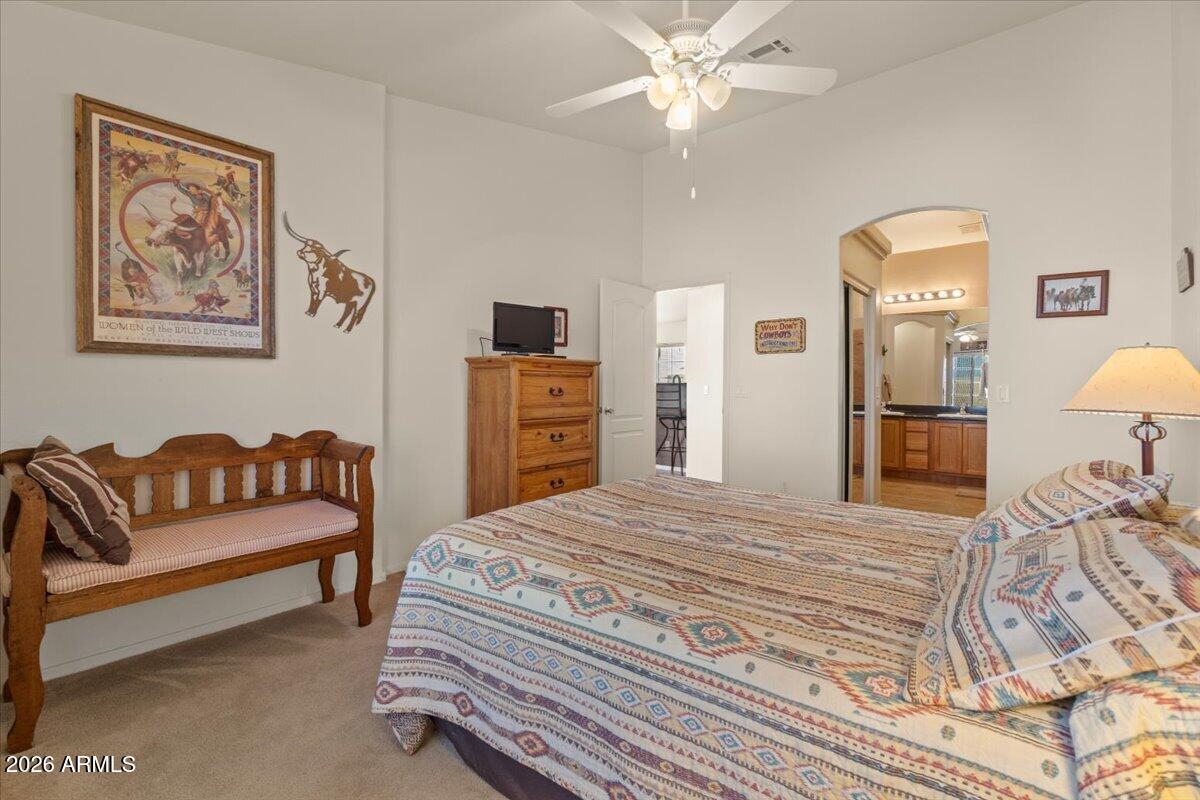 14234 South Capistrano Road Arizona City, AZ 85123 - Photo 20 of 42 a bedroom with a bed and dresser with mirror