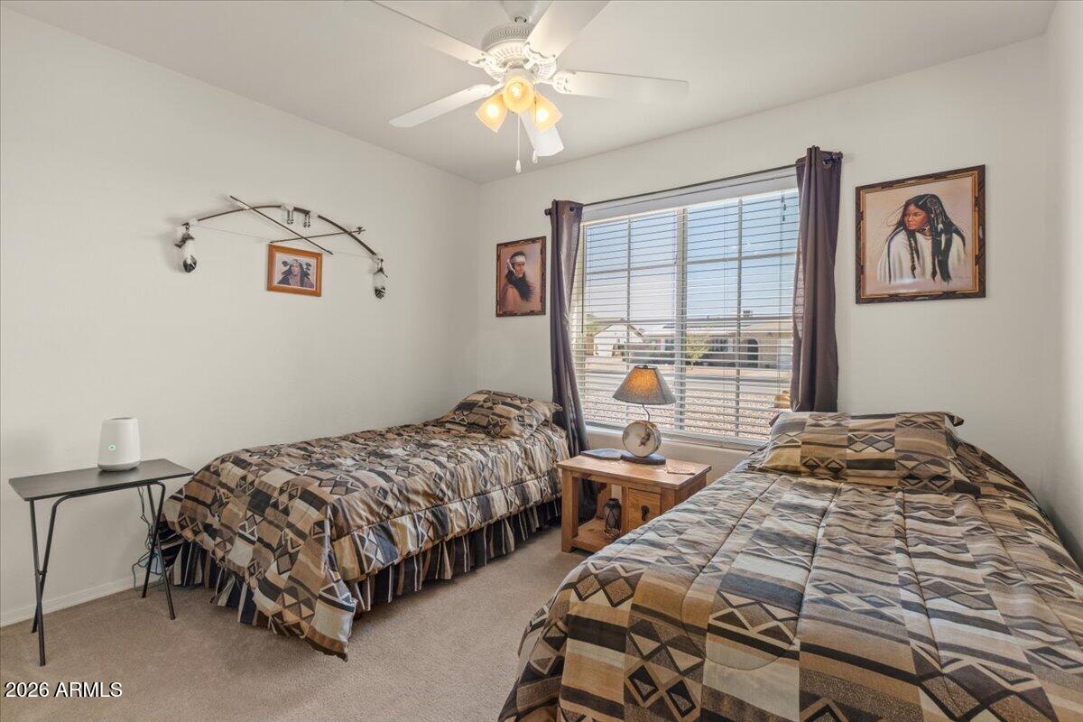14234 South Capistrano Road Arizona City, AZ 85123 - Photo 23 of 42 a bedroom with two beds and a window