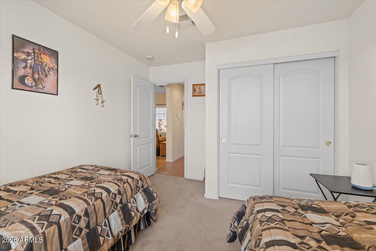 14234 South Capistrano Road Arizona City, AZ 85123 - Photo 24 of 42 a bedroom with a bed and a chandelier