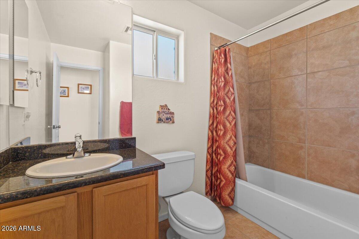 14234 South Capistrano Road Arizona City, AZ 85123 - Photo 25 of 42 a bathroom with a granite countertop sink toilet and shower