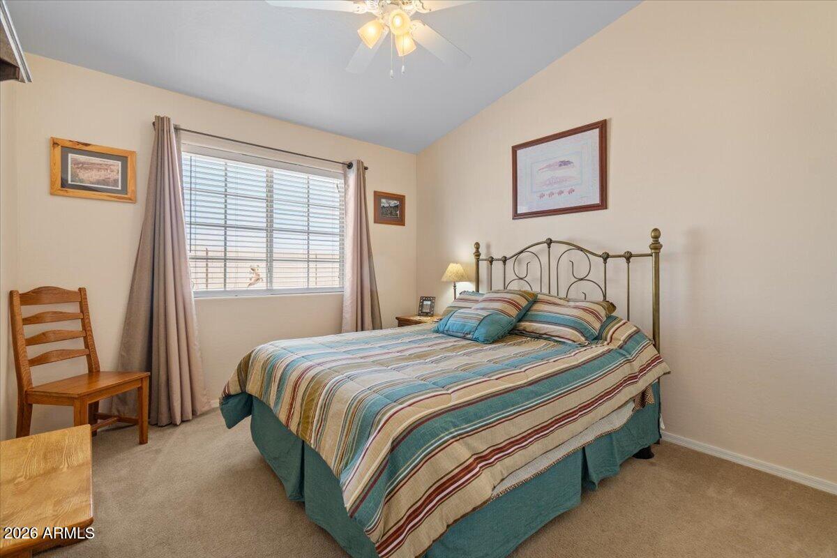 14234 South Capistrano Road Arizona City, AZ 85123 - Photo 26 of 42 a bedroom with a bed and a chandelier
