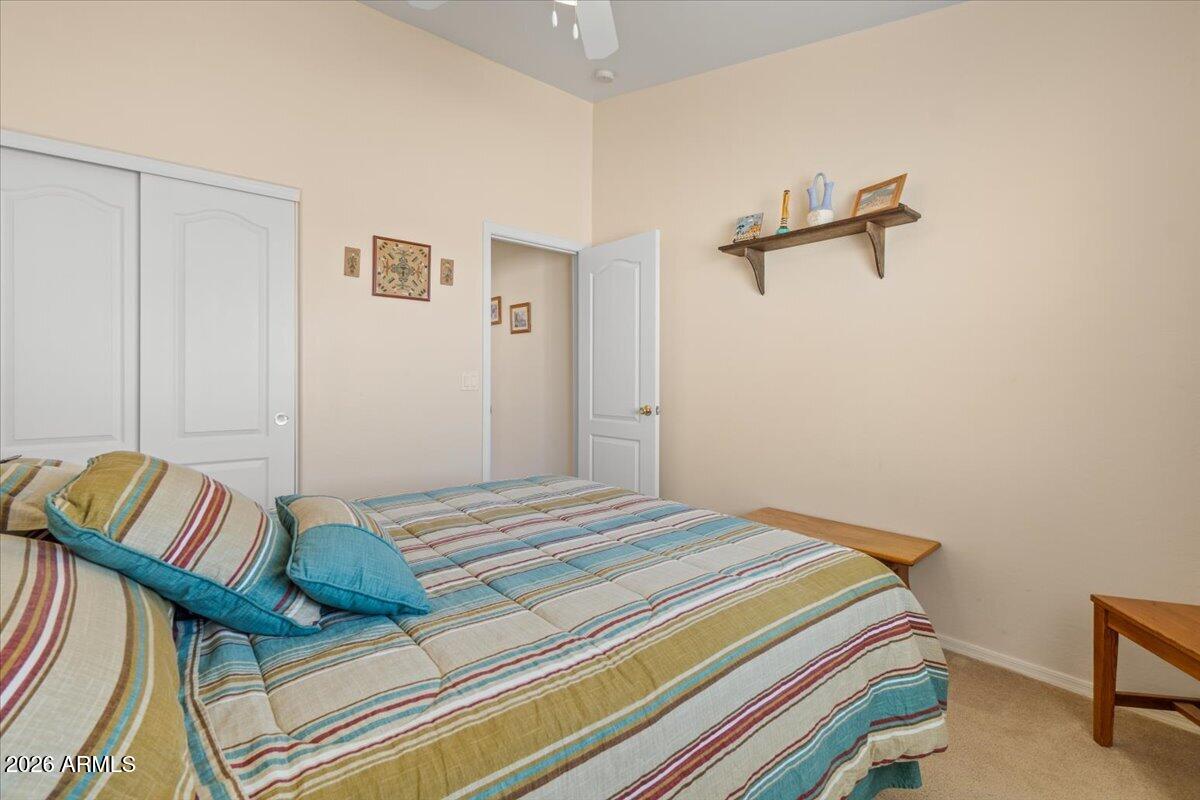 14234 South Capistrano Road Arizona City, AZ 85123 - Photo 27 of 42 a bedroom with a bed and a cabinets