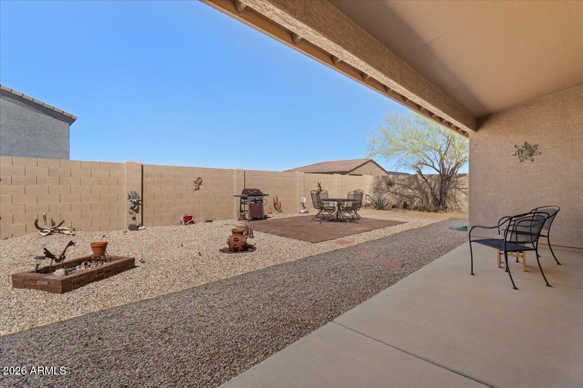 14234 South Capistrano Road Arizona City, AZ 85123 - Photo 29 of 42 a bedroom with furniture and a large window