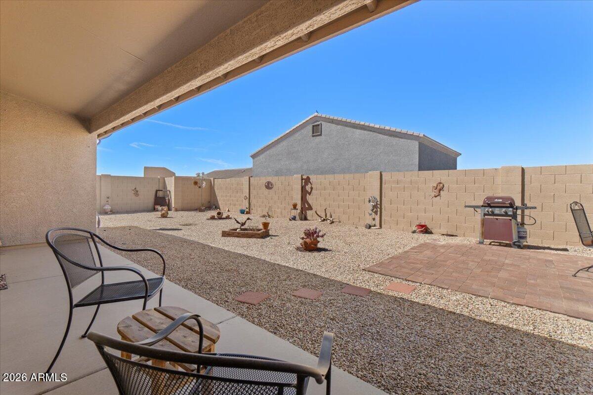 14234 South Capistrano Road Arizona City, AZ 85123 - Photo 30 of 42 a view of a house with backyard and sitting area