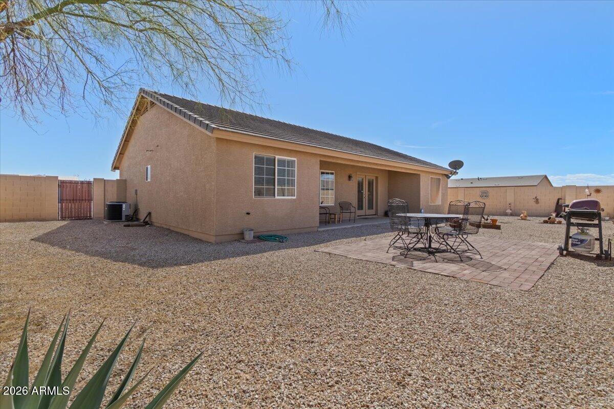 14234 South Capistrano Road Arizona City, AZ 85123 - Photo 34 of 42 a backyard of a house with table and chairs