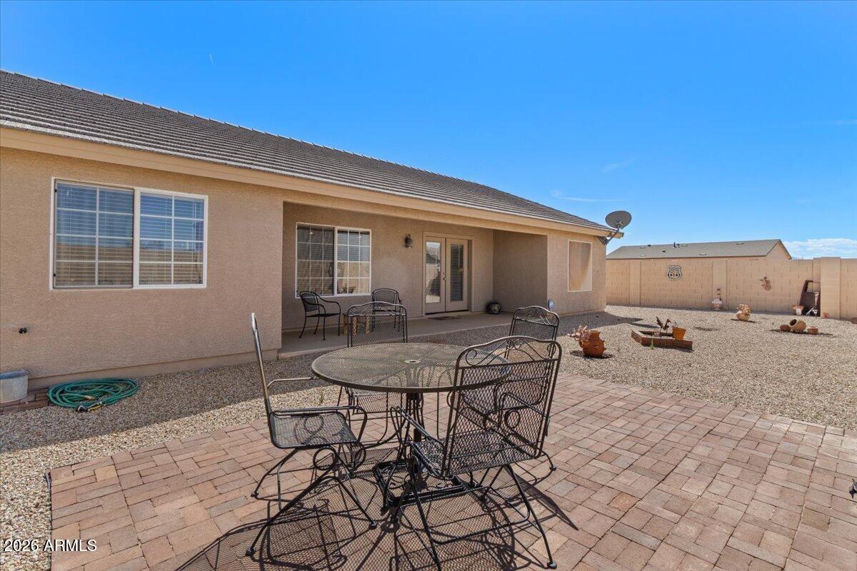 14234 South Capistrano Road Arizona City, AZ 85123 - Photo 35 of 42 a backyard of a house with table and chairs
