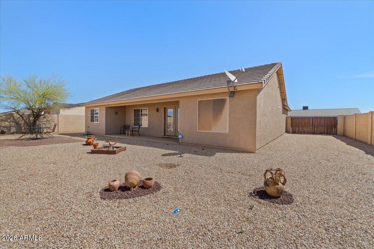 14234 South Capistrano Road Arizona City, AZ 85123 - Photo 37 of 42 a backyard of a house with fire pit and outdoor space