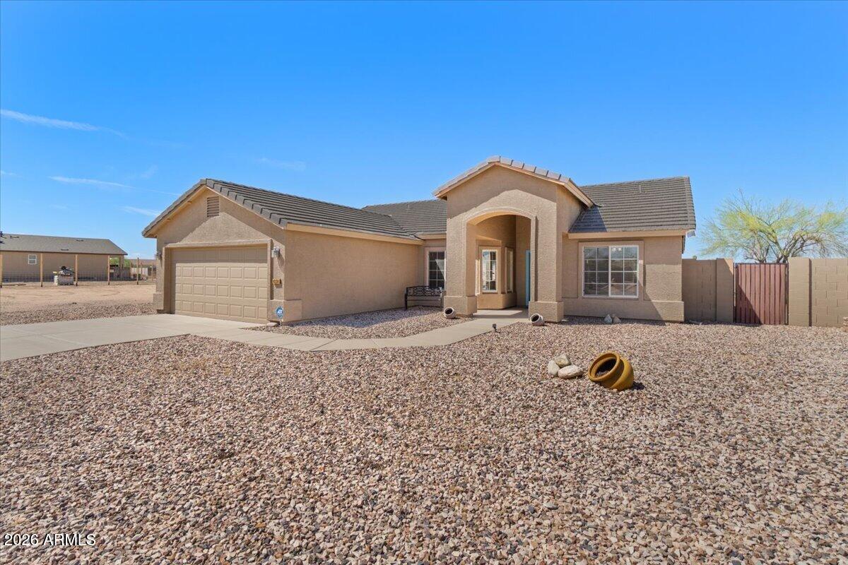 14234 South Capistrano Road Arizona City, AZ 85123 - Photo 40 of 42 a front view of a house with a yard
