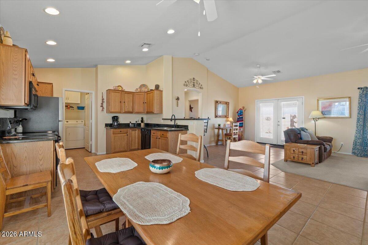 14234 South Capistrano Road Arizona City, AZ 85123 - Photo 6 of 42 a dining room with furniture a large window and chairs